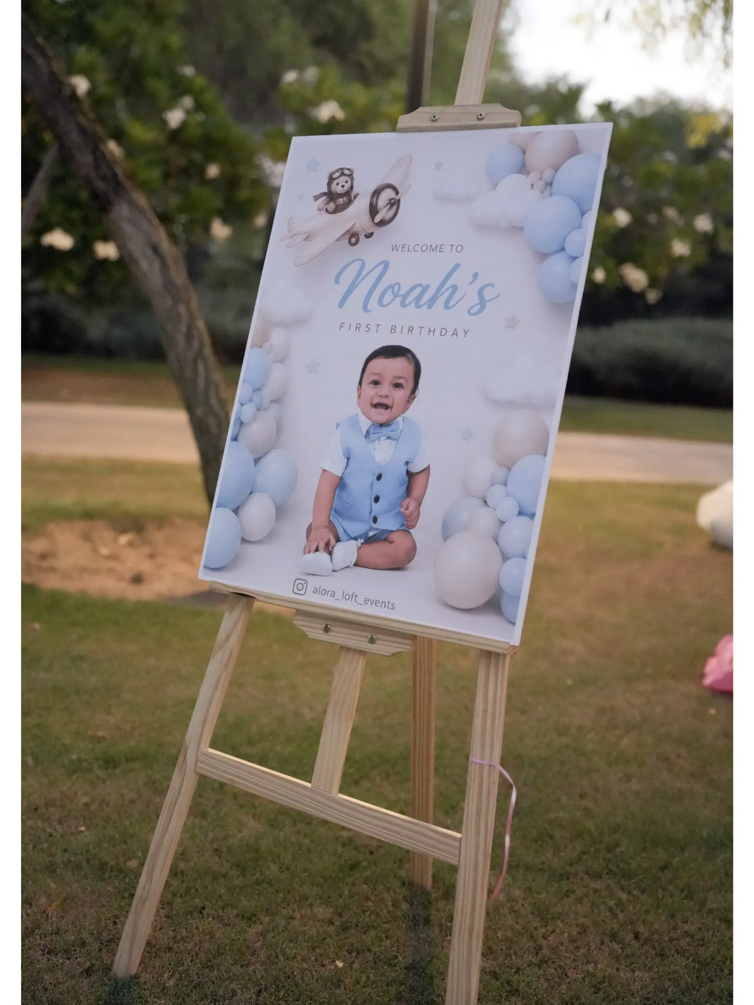 First birthday welcome sign photographed outdoors