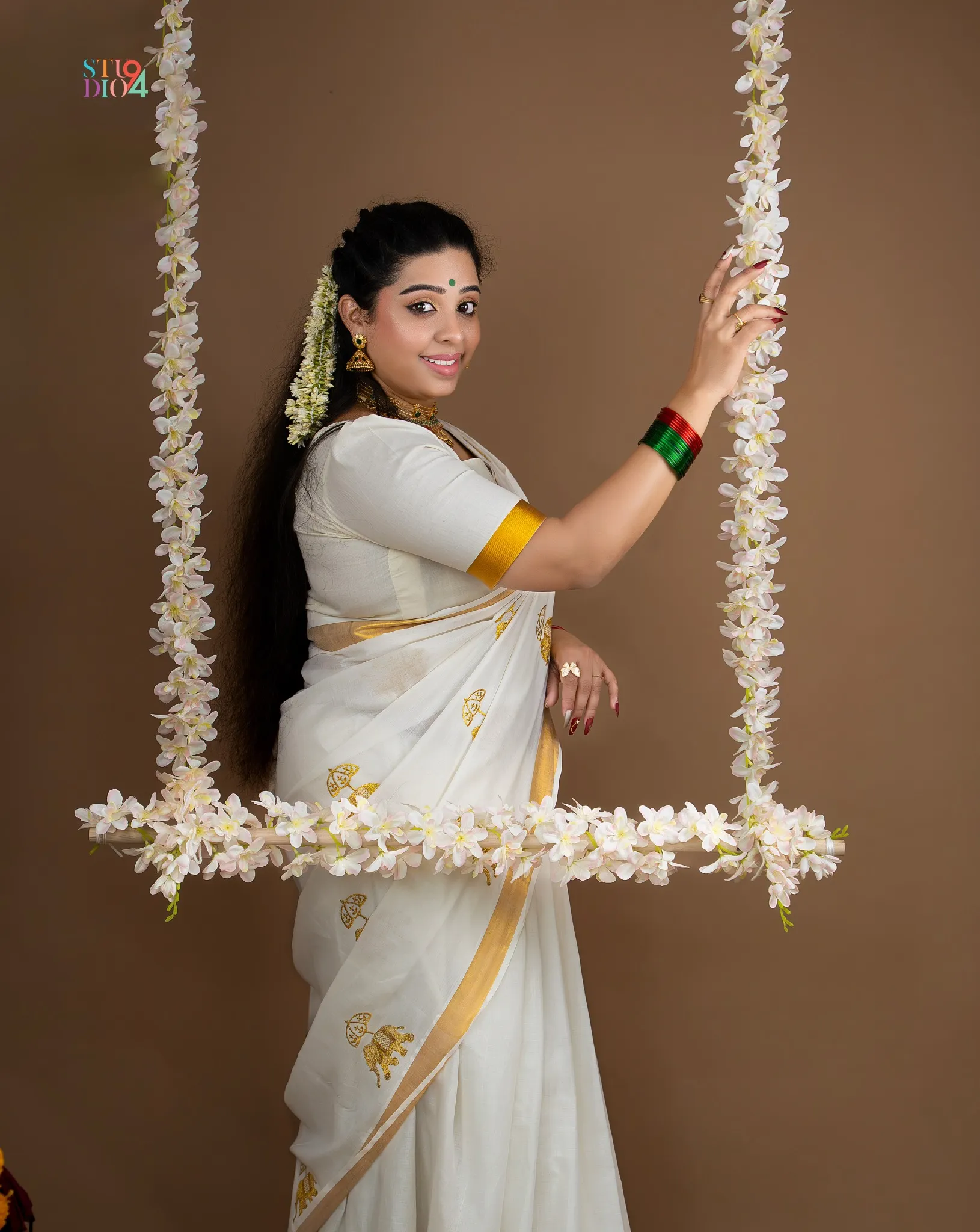 Cultural studio portrait on a floral swing